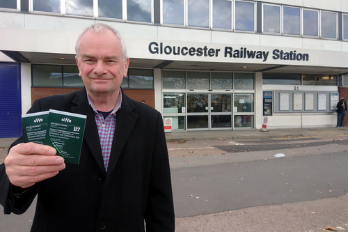 Jeremy Hilton at Gloucester Railway Station, with current timetable to London
