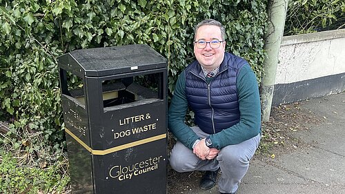 Councillor Field with one of the two new litter bins at the Stroud Road entrance to the ash path