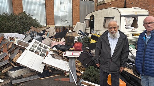 Cllr Usman Bhaimia and a local resident outside the former school